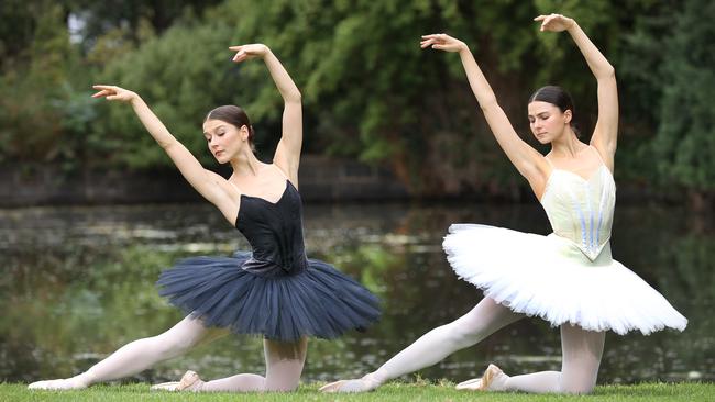 WARNING EMBARGOED. Australian Ballet dancers Benedicte Bemet (correct) as the black swan and Valerie Tereshchenko as the white swan, at the Royal Botanical Gardens to announce a reimagined version of Swan Lake.                     Picture: David Caird