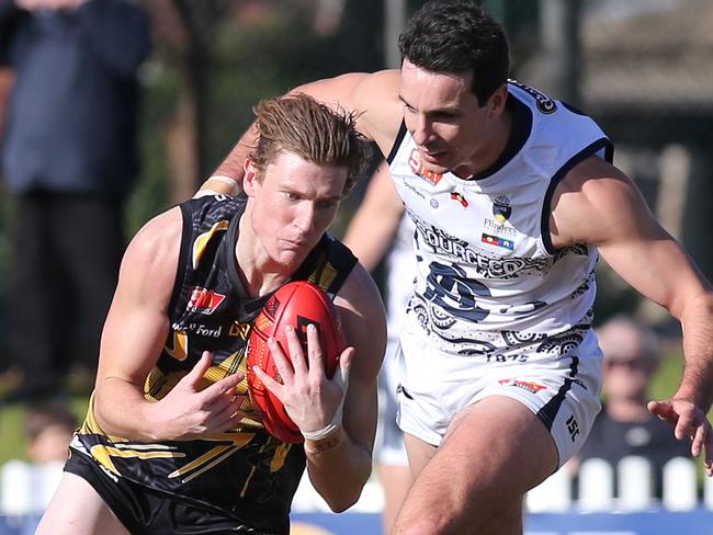 SANFL: Glenelg v South Adelaide at Glenelg Oval. Glenelg's Lachlan Hosie takes a strong mark in front of South's Jake Summerton, and goes on to kick a goal.Pic. Dean Martin