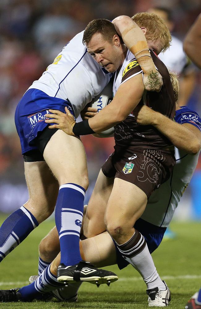 Penrith's Trent Merrin tackled by Bulldogs James Graham during NRL match Penrith Panthers v Canterbury Bulldogs at Penrith. Picture. Phil Hillyard