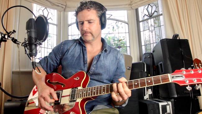 Wentworth's Bernard Curry playing guitar in his converted music room. Pic: Bernard Curry