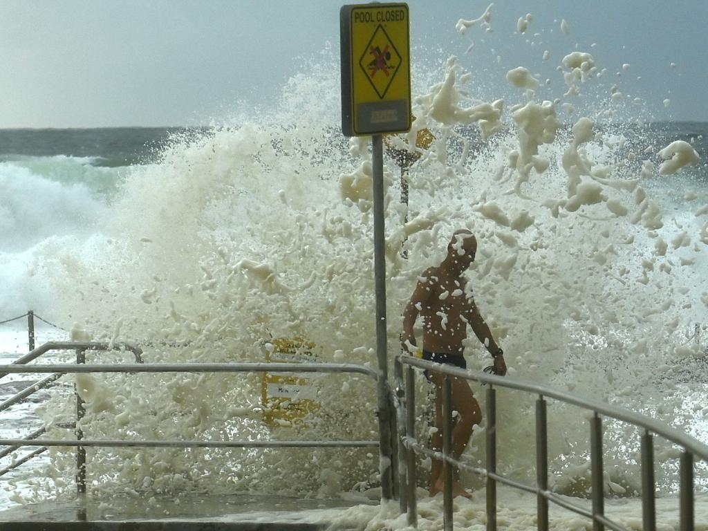 Swimmers take to the water at Curl Curl Beach as large swells begin to build along the northern beaches. Picture: NCA NewsWire / Jeremy Piper