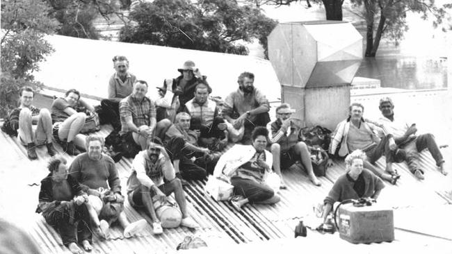 A group of people on top of the Victoria Hotel kitchen, waiting for a rescue helicopter. Charleville 1990 flood.