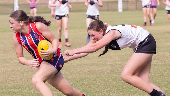 Wilston Grange player Tayla Simpson tries to run free.