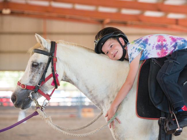 Max Lenoir, 8, with Kev the pony at Riding for the Disabled. Picture: GLENN CAMPBELL