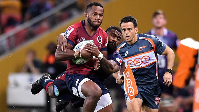 Queensland’s Filipo Daugunu is tackled by Melbourne’s Marika Koroibete on Friday night.