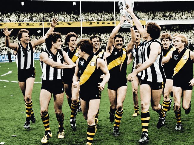 Mick Malthouse holds the premiership cup aloft during a lap of honour after the 1980 Grand Final.