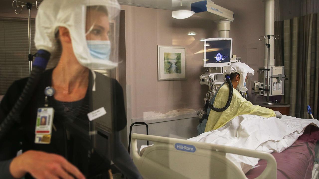 Registered nurses Lindsey Ryan (L) and Carrie Tang provide post-mortem care to a deceased COVID-19 patient in the Intensive Care Unit at Sharp Grossmont Hospital in California. Picture: Mario Tama/Getty Images/AFP