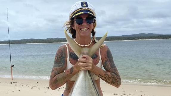 Sammie Holland with a "dream" 20kg golden trevally she reeled in while holidaying at Inskip Point on January 7, 2024.