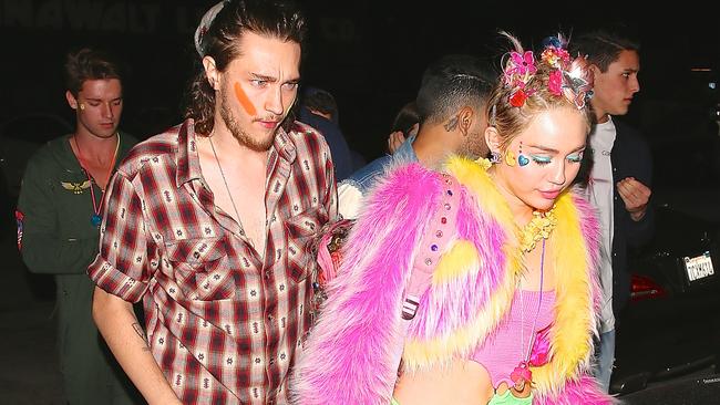 Just being Miley ... Miley and boyfriend Patrick both had their faces painted. Picture: Splash