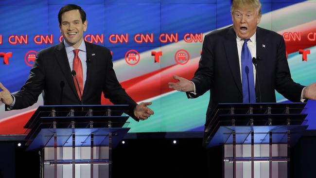 Smiling assassin... Rubio needles Trump during the debate.