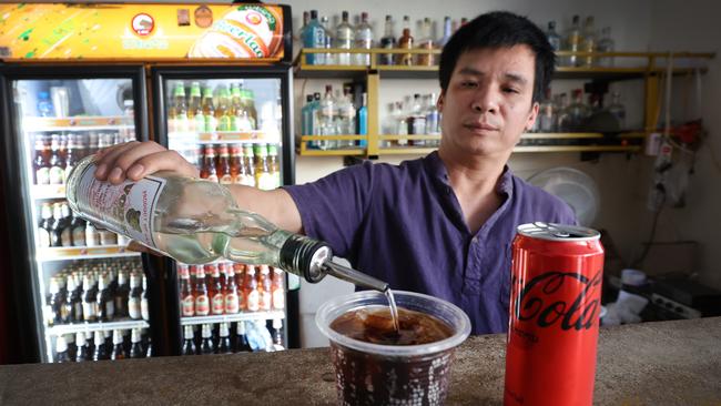 Nana Backpackers Hostel bar tender Toan Van Vanng pours in the same Vodka and Coke drink the girls had and drinks it.