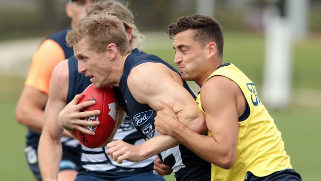 Cats recruit Luke Dahlhaus tackles Scott Selwood at training. Picture: Alison Wynd