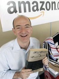 Amazon CEO Jeff Bezos holds up a copy of the first book sold on the site. Picture: News Corp Australia