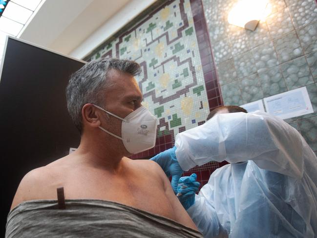 A man is vaccinated at the vaccination center in Amalienbad in Vienna, Austria, February 05, 2022. - Austria's president on February 4, 2022 signed a law making Covid-19 vaccination mandatory for all adults, a first in the European Union. (Photo by ALEX HALADA / AFP)