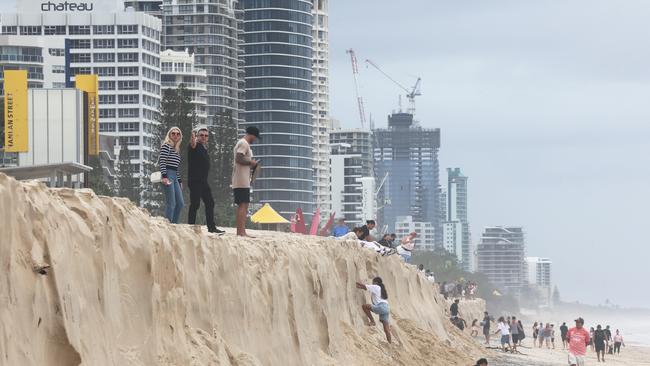 Gold Coast show the scars from Cyclone Alfred. The scarping on Surfers beach became an ideal place to write your name or leave a message. . Picture Glenn Hampson