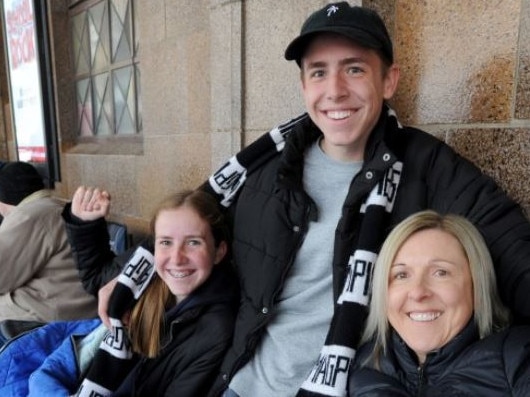 Collingwood fans Cindy Pannam with her kids Jade, 13, and Liam, 16, line up for Grand Final tickets outside the Exhibition Street Ticketek outlet. Picture: Andrew Henshaw