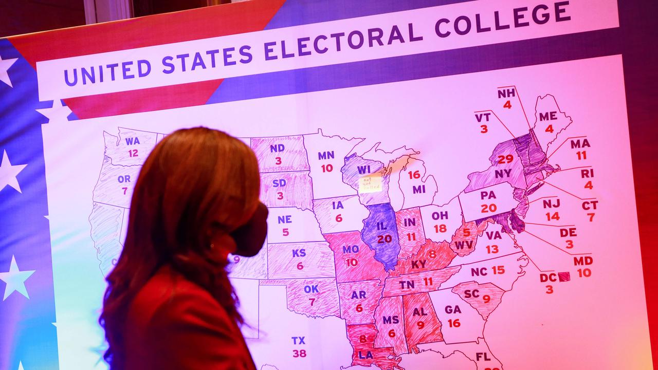 A woman walks past an electoral map at the US embassy in Ulaanbaatar, the capital of Mongolia. Picture: Byambasuren BYAMBA-OCHIR / AFP