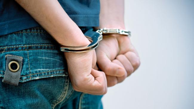 Generic Thinkstock image of youth crime - hand cuffs teenager under arrest.