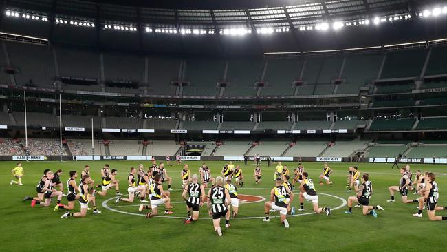 Richmond and Collingwood players take a knee in a poignant moment before footy’s return.