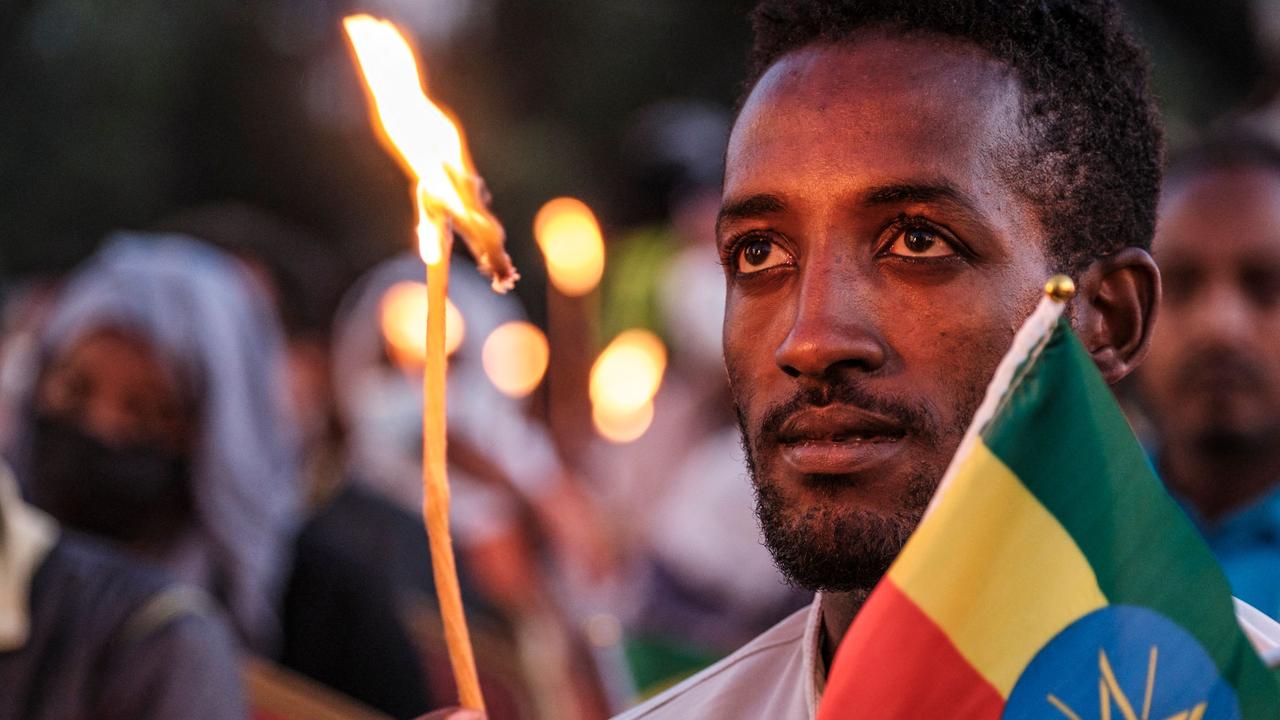 A man holds a candle during a memorial service for the victims of the Tigray conflict organised by the city administration in Addis Ababa. Picture: Eduardo Soteras/AFP