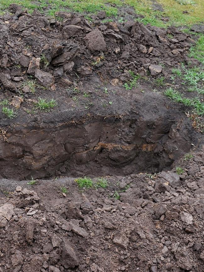 Saltmarsh laid beside and in the hole to measure its dimensions. Picture: Supplied