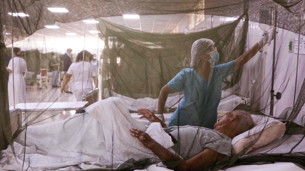 A nurse takes care of a dengue fever patient at the Sergio Bernales National Hospital in the outskirts of Lima in Peru. Picture: Juan Carlos CISNEROS / AFP.