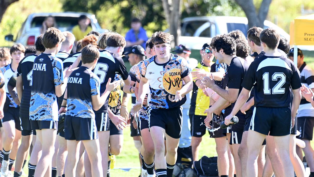 Will Lane leads his school First XV, Iona College, onto the field. Picture, John Gass