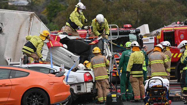 Emergency services personnel at the latest crash at the bottom of the South Australian Freeway. Picture: Keryn Stevens