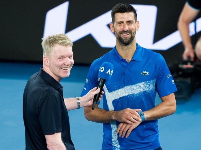 MELBOURNE, AUSTRALIA - JANUARY 21: Novak Djokovic (R) of Serbia gives an on-court interview after victory against Carlos Alcaraz of Spain in the Men's Singles Quarterfinal match during day 10 of the 2025 Australian Open at Melbourne Park on January 21, 2025 in Melbourne, Australia. (Photo by Andy Cheung/Getty Images)