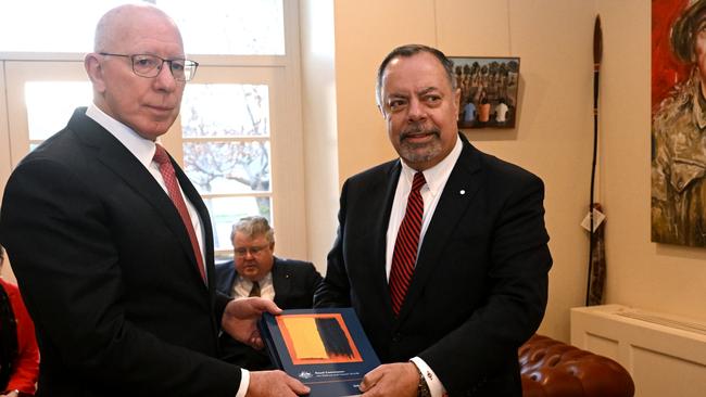 Royal Commission into Defence and Veteran Suicide chair Nick Kaldas (right) hands an interim report to Governor-General David Hurley at Government House in Canberra on August 11, 2022. Commissioner James Douglas sits in the background. Picture: NCA NewsWire / Mick Tsikas