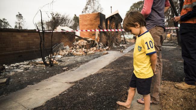 Villiam Collier, 3, in front of what was his family's home in Rappville. Picture: Dylan Robinson