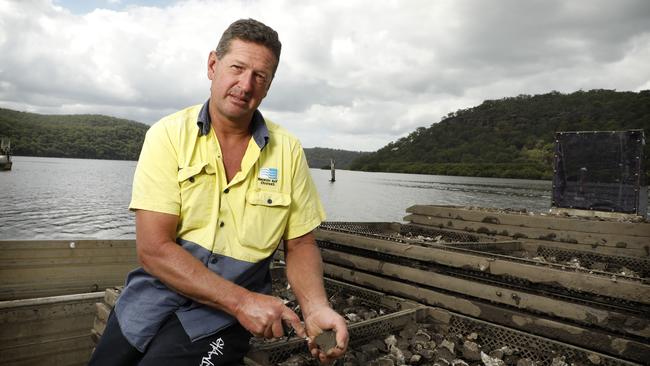 Bruce Alford loads an oyster punt on the Hawkesbury River. Picture: Chris Pavlich