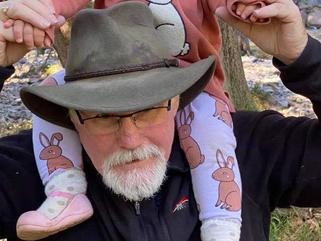 Nigel Harris with his granddaughter Evelyn. The 60-year-old was tragically killed when a vehicle veered off the road and into spectators at the Finke Desert Race on Monday. Picture: Facebook.