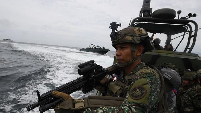 A Philippine marines aboard a patrol boat during a joint exercise with US and South Korean counterparts with Japan's self-defence forces as observers, in Cavite province, west of Manila. Picture: AFP