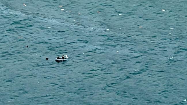 The Sunshine Coast-based RACQ LifeFlight Rescue helicopter located two men in a dinghy, surrounded by wreckage, after their boat sunk, off a beach north of Noosa. Picture: RACQ LifeFlight