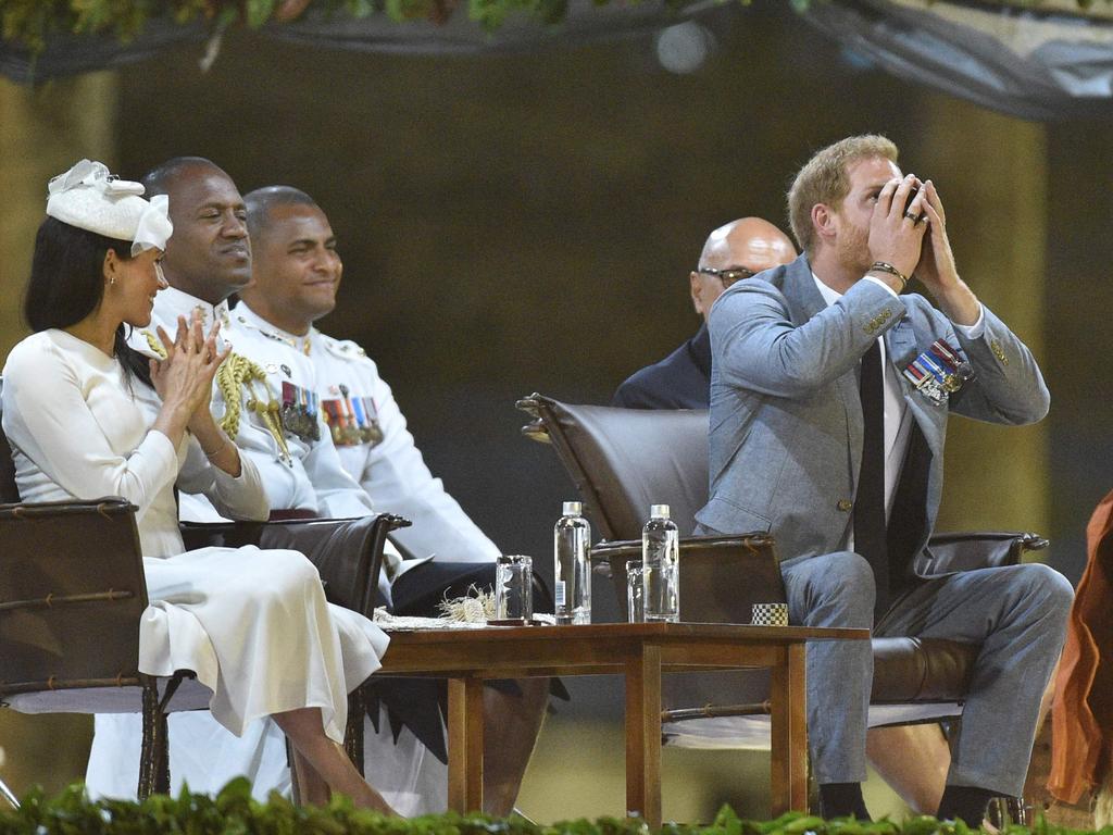 Meghan claps with delight as Harry downs the kava.