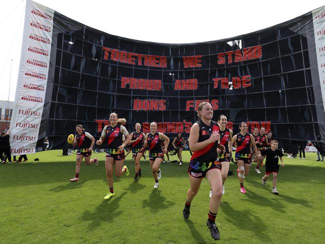 Bombers players run through the banner in Round 8. Picture: Martin Keep/AFL Photos/via Getty Images.