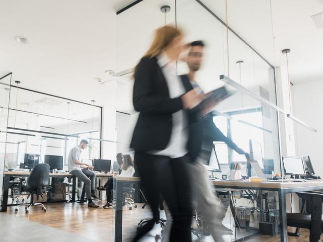 Business colleagues walking and talking  iStock office generic