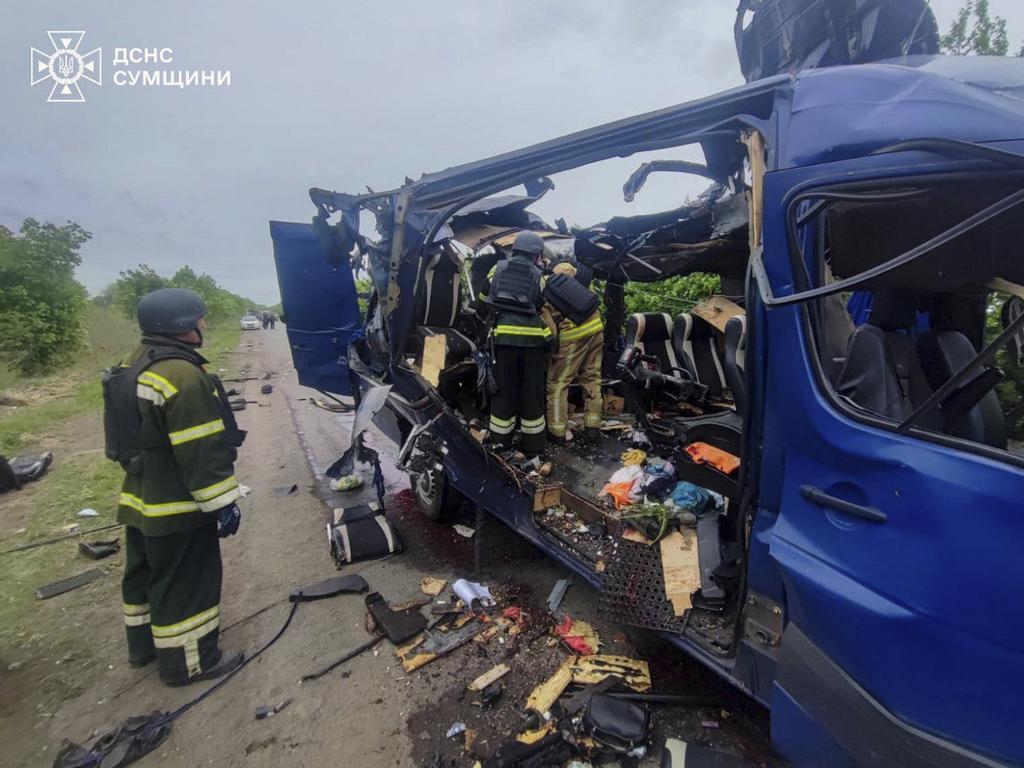 Rescuers recover the bodies of passengers after a Russian drone struck a passenger bus at the village of Bilopillya in the Sumy region, Ukraine. Picture: AP