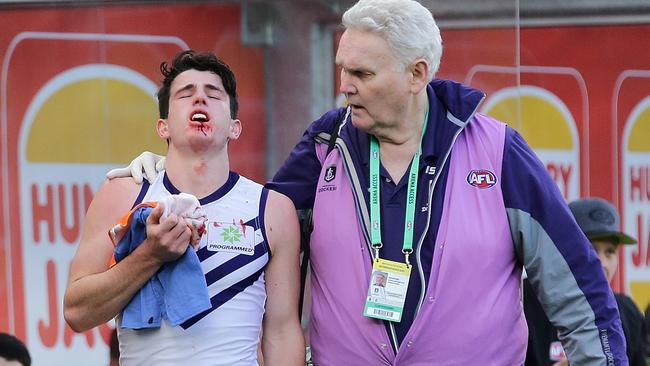 Andrew Brayshaw is helped from the field on Sunday.