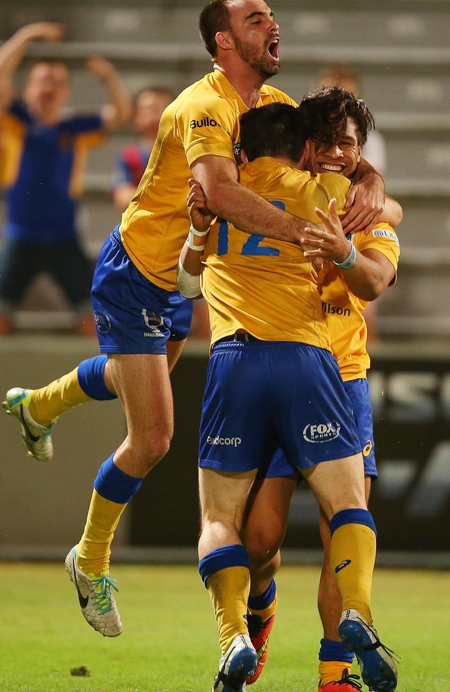 Junior Laloifi is congratulated after scoring a try for Brisbane City.