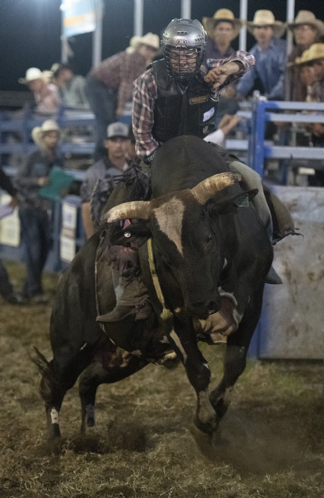 Local Ehtan McConnell rides in the top eight chute out at the Lawrence Twilight Rodeo. Picture: Adam Hourigan