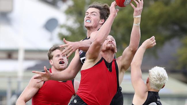 Tom Clurey marks in front of Wylie Buzza and Tom Jonas at Port training. Picture: Sarah Reed.