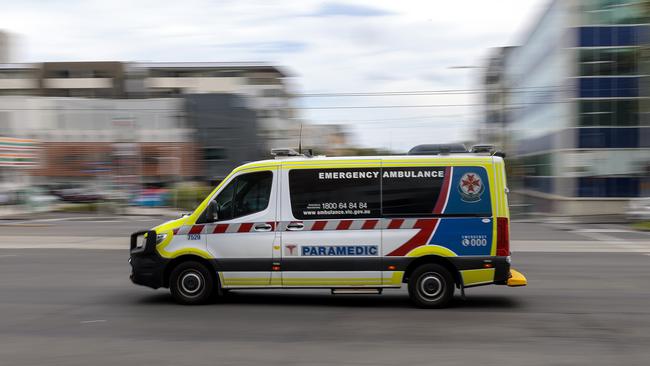 MELBOURNE, AUSTRALIA - NewsWire Photos FEBRUARY 13, 2022: An ambulance speeds away from the Royal Melbourne Hospital. Ambulance, Generic.Picture: NCA NewsWire / David Geraghty