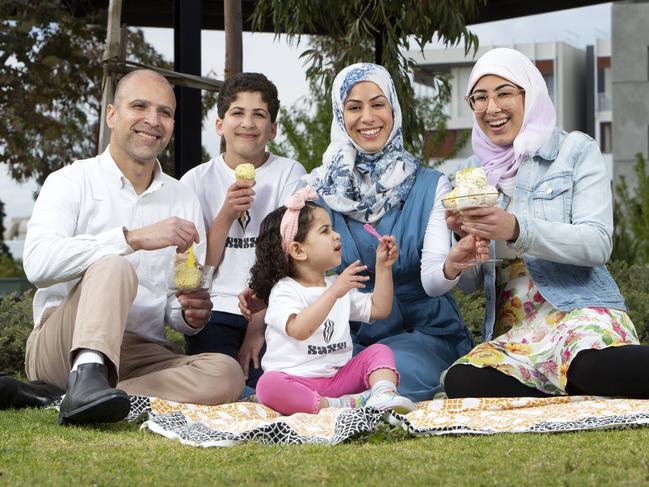 Huda Al Sultan, centre, enjoying her home-made Sassi ice cream with husband Adam, daughters Sidra and Renad, and son Mohammed. Photo: AAP/Emma Brasier