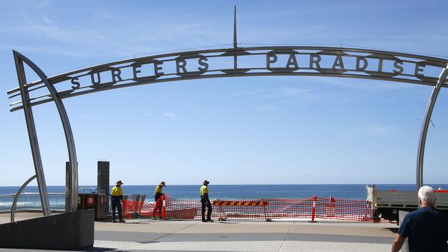 Council workers remove the barricades at Surfer Paradise, opening the beaches, after a closure in March due to COVID-19 fears. Picture: Tertius Pickard.