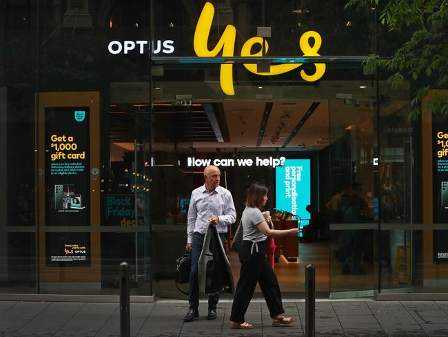 SYDNEY, AUSTRALIA - NOVEMBER 21: Pedestrians walk past an Optus store in the CBD on November 21, 2023 in Sydney, Australia. Optus' CEO Kelly Bayer Rosmarin stepped down on Monday after an extended outage last week caused millions of Australians to be disconnected from the network, with no access to emergency numbers for hours. The outage followed a hack that saw millions of customers' data shared online last year. (Photo by Lisa Maree Williams/Getty Images)