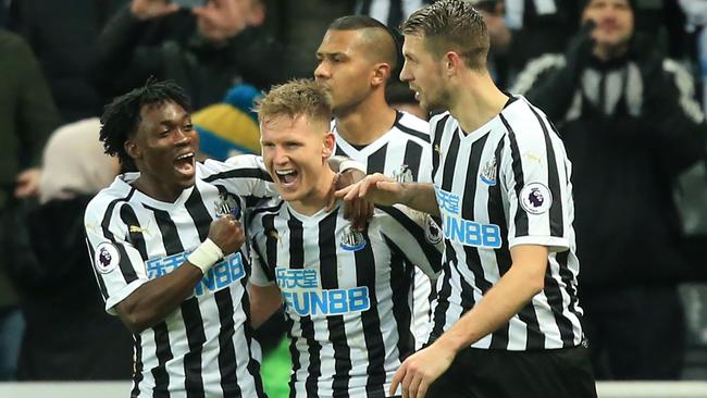 Newcastle United's Matt Ritchie, centre, celebrates with teammates after scoring their second goal from the penalty spot against Manchester City. Picture: AFP