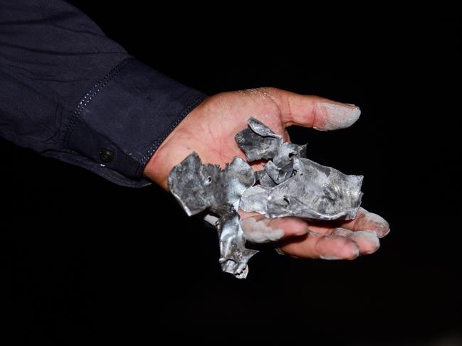 A local resident shows pieces of a suspected Indian missile at the site of the Muzaffarabad attack. Picture: AP