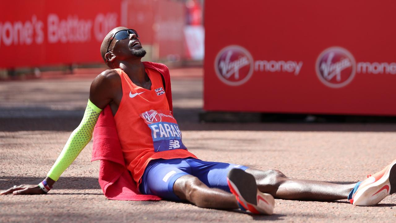 Third-placed Britain's Mo Farah reacts after crossing the finish line.